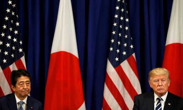 US President Donald Trump and Japanese Prime Minister Shinzo Abe listen to translations as they meet during the UN General Assembly in New York, US, 21 September 2017. (Photo: Reuters/Kevin Lamarque).