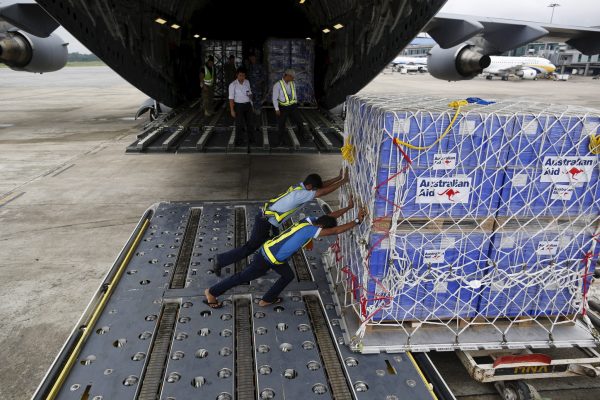 Workers unload aid from an Royal Australian Air Force transport plane carrying donated aid for Myanmar's flood victims at Yangon international airport, 10 August 2015 (Photo: Reuters/Soe Zeya Tun).