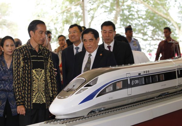Indonesian President Joko Widodo and the former general manager of China Railway Corporation Sheng Guangzu stand next to a model of a train while attending a ground breaking ceremony for the Jakarta-Bandung fast-train railway line in Walini, West Java province, Indonesia, 21 January 2016. (Photo: Reuters/Garry Lotulung).