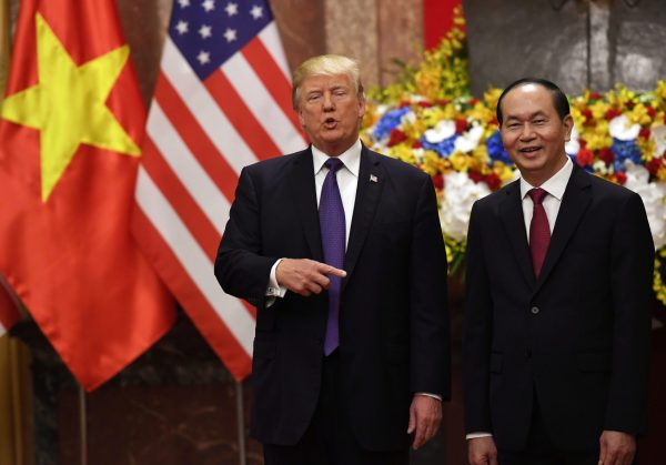 US President Donald Trump gestures as he poses with Vietnamese President Tran Dai Quang during a welcoming ceremony at the Presidential Palace in Hanoi, Vietnam, 12 November 2017 (Photo: Reuters/Hoang Dinh Nam).