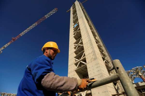 A Chinese worker is seen below the 270-metre-high minaret at the construction site of the new Great Mosque of Algiers, called Djemaa El Djazair, which is being built by the China State Construction Engineering Corporation, and overseen by Algeria's National Agency for Realization and Management in Algiers, Algeria 7 February 2017. (Photo: Reuters/Zohra Bensemra).
