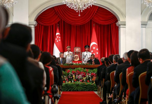 President Halimah Yacob delivers a speech while flanked by Singapore Prime Minister Lee Hsien Loong and Chief Justice Sundaresh Menon during the presidential inauguration ceremony at the Istana Presidential Palace in Singapore, 14 September 2017 (Photo: Reuters/Wallace Woon).