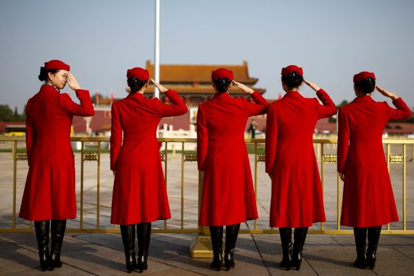 Ushers salute in Tiananmen Square outside the Great Hall of the People before the start of the closing session of the 19th National Congress of the Communist Party of China, 24 October 2017 (Photo: Reuters/Thomas Peter).