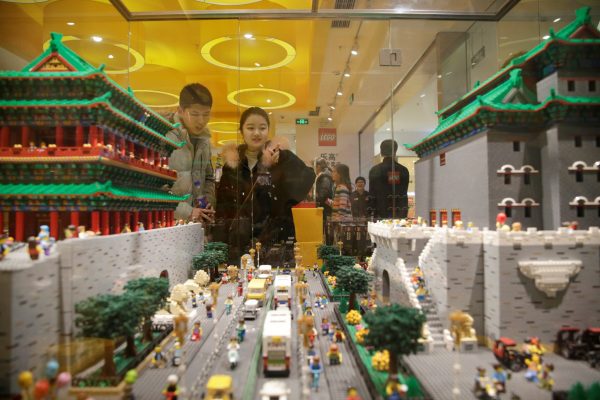 Customers look at Gate Towers of Zhengyang and Qianmen (part of Forbidden City) that were made with Lego bricks at a Lego store in Beijing, China, 13 January 2018 (Photo: Reuters/Jason Lee).
