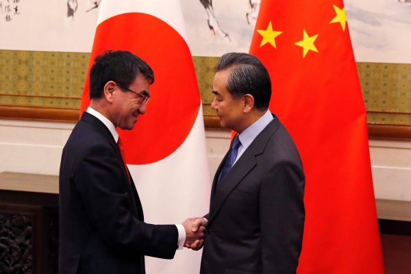 Japanese Foreign Minister Taro Kono (L) shakes hands with his Chinese counterpart Wang Yi before their meeting at the Diaoyutai State Guesthouse in Beijing, China on 28 January 2018. (Photo: Reuters/Andy Wong).