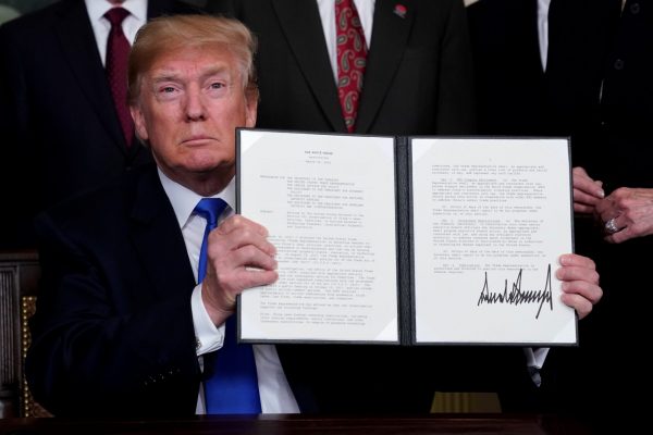 US President Donald Trump holds his signed memorandum on intellectual property tariffs on high-tech goods from China, at the White House in Washington, United States on 22 March 2018. (Photo: Reuters/ Jonathan Ernst)