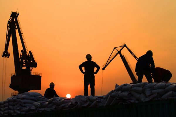 Workers load imported goods at a port in Nantong, Jiangsu province, 24 February 2016 (Photo: Reuters/China Daily).