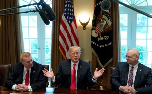 Chairman, CEO and President of Nucor John Ferriola and US Steel CEO Dave Burritt flank US President Donald Trump as he announces that the United States will impose tariffs of 25 per cent on steel imports and 10 per cent on imported aluminium during a meeting at the White House in Washington DC, United States, 1 March 2018 (Photo: Reuters/Kevin Lamarque).