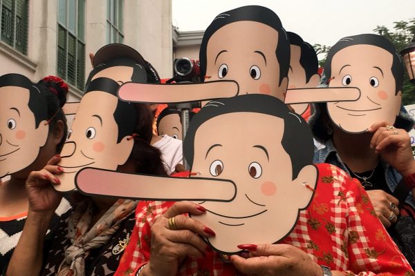 Pro-democracy activists wear masks mocking Thailand's Prime Minister Prayuth Chan-ocha as Pinocchio during a protest against the junta at a university in Bangkok, Thailand on 24 February 2018. (Photo: Reuters/Panarat Thepgumpanat).