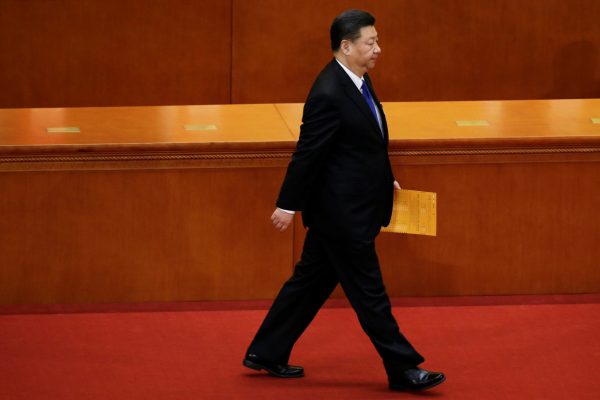 Chinese President Xi Jinping walks with his ballot at the seventh plenary session of the National People's Congress at the Great Hall of the People in Beijing, China, 19 March 2018 (Photo: Reuters/Jason Lee).