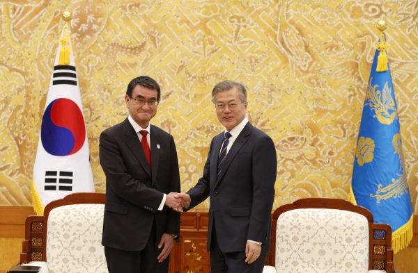 South Korean president Moon Jae-in shakes hands with Japanese foreign minister, Taro Kono, prior their meeting at the presidential house in Seoul, South Korea, 11 April 2018 (Photo: Kim Hee-Chul/Pool).