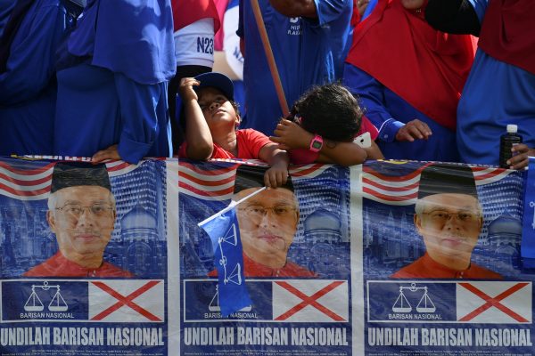 A boy holds a Barisan Nasional flag during nomination day in Pekan, Pahang, Malaysia on 28 April 2018. (Photos: Reuters/Stringer).