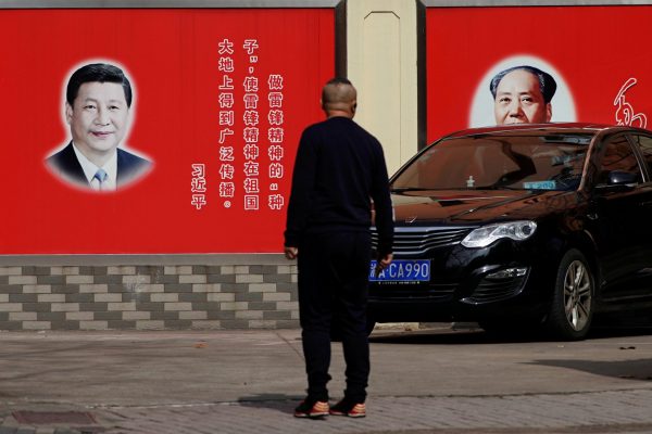 Pictures of Chinese President Xi Jinping and late Chinese Chairman Mao Zedong overlook a street in Shanghai, China on 26 February 2018. (Photo: Reuters/Aly Song).