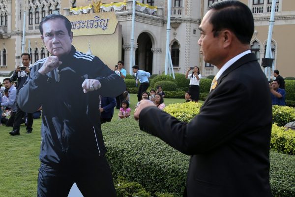 Thailand's Prime Minister Prayuth Chan-o-cha walks next to his cardboard cutout during preparations for national Children's Day at the Government House in Bangkok, Thailand, 12 January 2018 (Photo: Reuters/Athit Perawongmetha).