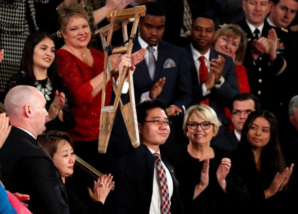 North Korean defector Ji Seong-ho, currently a law student at Dongguk University, holds up his crutches during US President Donald Trump's State of the Union address to a joint session of the US Congress on Capitol Hill in Washington, US, 30 January 2018 (Photo: Reuters/Jonathan Ernst).
