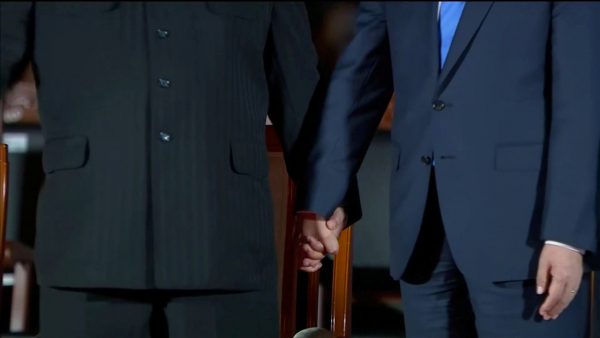 South Korean President Moon Jae-in and North Korean leader Kim Jong-un hold hands during a farewell ceremony after the inter-Korean summit at the truce village of Panmunjom, South Korea, 27 April 2018 (Photo: Host Broadcaster via Reuters TV).