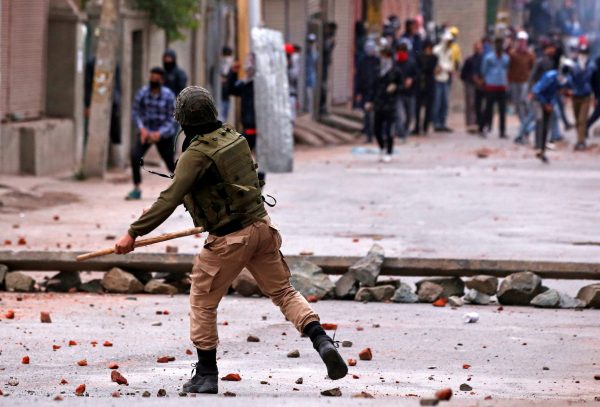 Demonstrators throw stones towards the Indian police during a protest against the recent killings in Kashmir, in Srinagar, 8 May 2018 (Photo: Reuters/Danish Ismail).