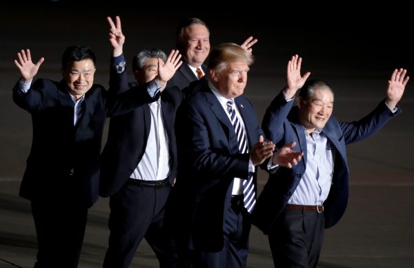 The three Americans formerly held hostage in North Korea gesture next to US President Donald Trump and Secretary of State Mike Pompeo upon their arrival at Joint Base Andrews, Maryland on 10 May 2018. (Photo: Reuters/Jim Bourg).