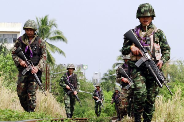 Thai security forces patrol the railway in the troubled southern province of Yala, 27 March 2013 (Photo: Reuters/Surapan Boonthanom).