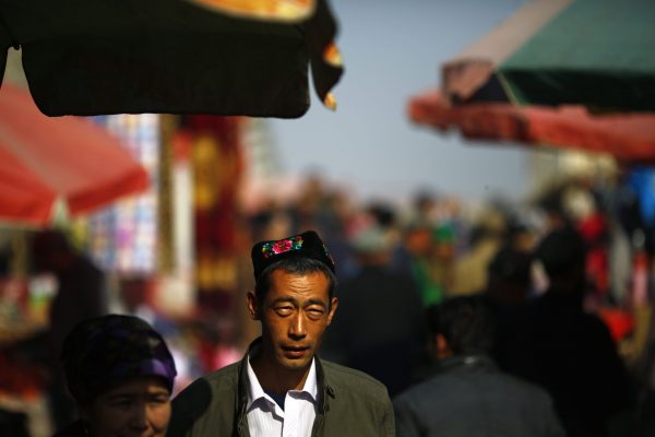 An ethnic Uighur man walks along a market in downtown Turpan, Xinjiang province on 31 October 2013. (Photo: Reuters/Carlos Barria).