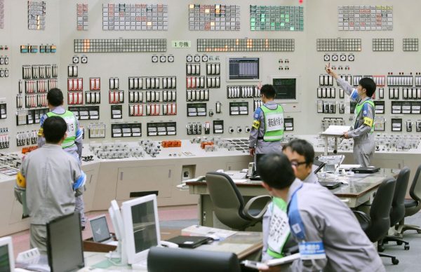 Employees of Kyushu Electric Power restart operations inside the central control room at Sendai nuclear power station in Satsumasendai, Kagoshima prefecture, Japan, 11 August 2015, in this photo released by Kyodo. Japan switched on a nuclear reactor for the first time in nearly two years on Tuesday, as Prime Minister Shinzo Abe seeks to reassure a nervous public that tougher standards mean the sector is now safe after the Fukushima disaster in 2011. Mandatory credit (Photo: Reuters/Kyodo).