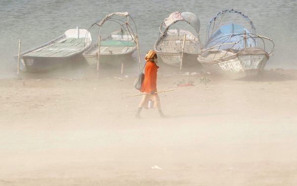 A Sadhu or a Hindu holy man walks on the banks of the river Ganges during a dust storm in Allahabad, India, 9 June 2016 (Photo: Reuters/Jitendra Prakash).
