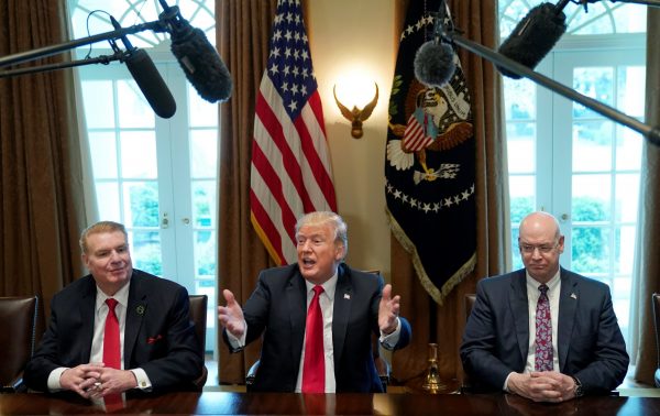Chairman, CEO and president of Nucor John Ferriola and US Steel CEO Dave Burritt flank US President Donald Trump as he announces that the United States will impose tariffs of 25 per cent on steel imports and 10 per cent on imported aluminum during a meeting at the White House in Washington, United States on 1 March 2018. (Photo: Reuters/Kevin Lamarque).