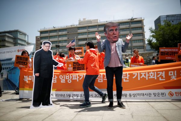 A man wearing a mask of US President Donald Trump performs next to a cutout of North Korean leader Kim Jong Un during an anti-Trump rally near the US embassy in Seoul, South Korea on 25 May 2018. (Photo: Reuters/Kim Hong-Ji)