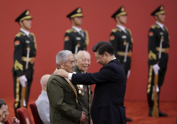 Chinese President Xi Jinping presents a commemorative medal to a veteran Shi Baodong at a medal ceremony marking the 70th anniversary of the Victory of Chinese People's War of Resistance Against Japanese Aggression, for World War Two veterans, at the Great Hall of the People in Beijing, China, 2 September 2015 (Photo: Reuters/Jason Lee).