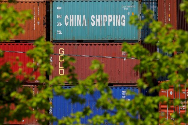 Shipping containers, including one labelled 'China Shipping', are stacked at the Paul W Conley Container Terminal in Boston, Massachusetts, US, 9 May 2018 (Photo: Reuters/Brian Snyder).