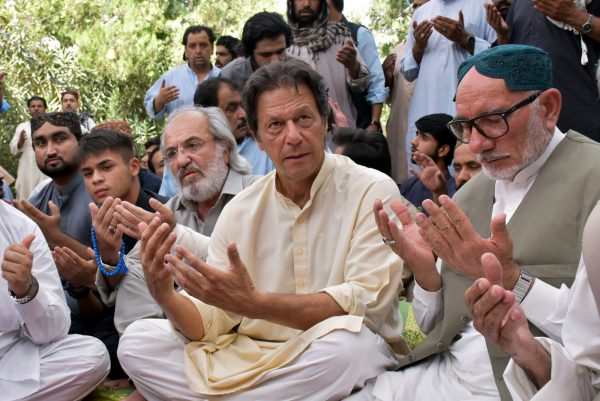 Imran Khan, chairman of the Pakistan Tehreek-e-Insaf, expresses condolences to the relatives of Siraj Raisani, a provincial assembly candidate of the Baluchistan Awami Party who was killed in a suicide attack during an election campaign meeting on 12 July, in Quetta, Pakistan on 15 July 2018. (Photo: Reuters/Naseer Ahmed.)