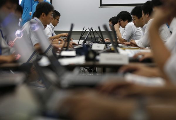 Participants from government ministries and agencies take part in the Cyber Defense Exercise with Recurrence in Tokyo, 25 September 2013. (Photo: Reuters/Toru Hanai).