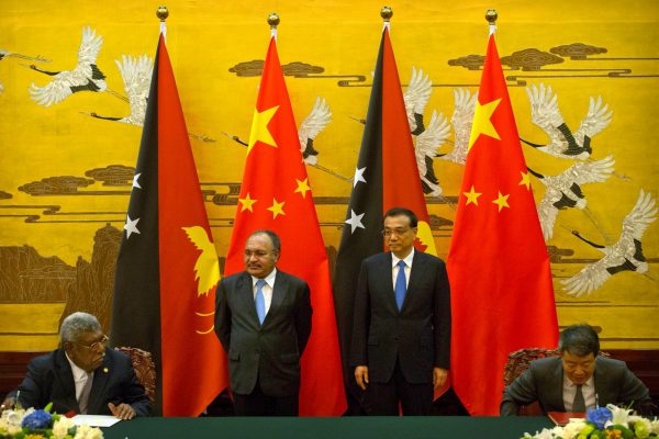 Papua New Guinea’s Prime Minister Peter O’Neill and Chinese Premier Li Keqiang watch a signing ceremony at the Great Hall of the People in Beijing, China. (Photo: Reuters/Mark Schiefelbein).