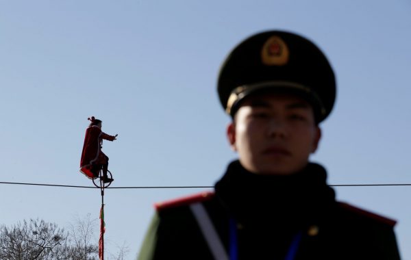 An acrobat rides a unicycle on tightrope during a temple fair celebrating the Chinese Lunar New Year at Daguanyuan park in Beijing, China, 30 January 2017 (Photo: Reuters/Jason Lee).