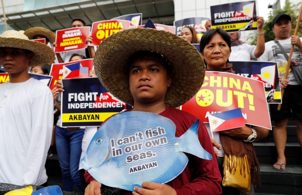 Members of Akbayan activist group display placards during a rally to protest what they say is harrassment of Filipino fishermen at the Scarborough Shoal in the disputed South China Sea, in Makati, Metro Manila in Philippines, 11 June 2018 (Photo: Reuters/Erik De Castro).