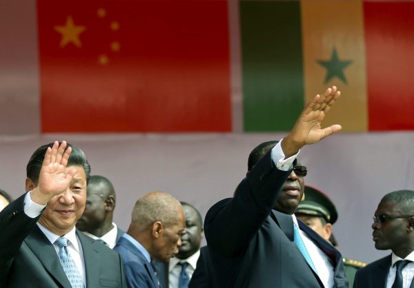 Senegal's President Macky Sall and Chinese President Xi Jinping wave as they enter the stadium during the opening ceremony for the Arene Nationale du Lutte, the Arene Nationale du Senegal in Dakar, Senegal, 22 July 2018 (Photo: Reuters/Mikal McAllister).