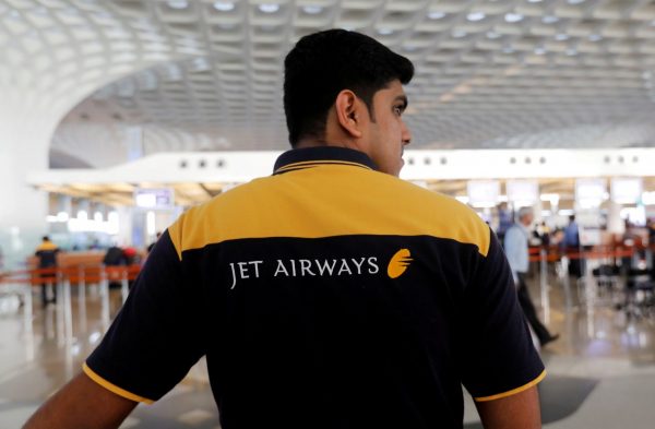 A Jet Airways employee waits to guide passengers at a check-in counter at the Chhatrapati Shivaji International airport in Mumbai, India, 14 February 2018 (Photo: Reuters/Danish Siddiqui).