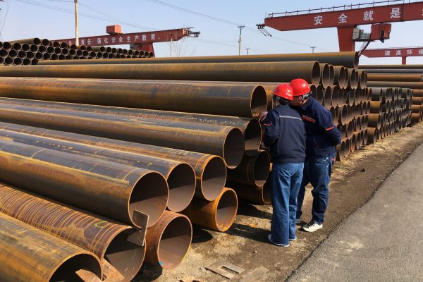 Workers inspect steel pipes at a steel mill of Hebei Huayang Steel Pipe Co Ltd in Cangzhou, Hebei province, China, 19 March 2018 (Photo: Reuters/Muyu Xu).