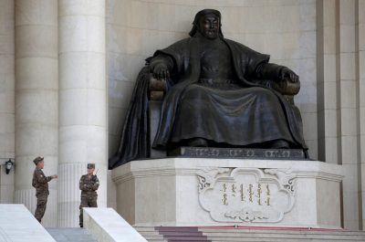 Security personnel chat next to the statue of Genghis Khan at the parliament buildingin Ulaanbaatar, Mongolia, 27 June 2016 (Photo: Reuters/Jason Lee).