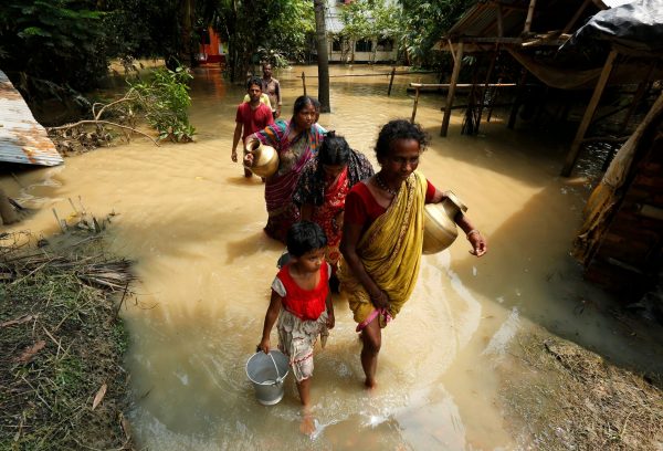 People wade through a flooded road to collect drinking water in Howrah district, West Bengal, India, 2 August 2017 (Photo: Reuters/Rupak De Chowdhuri).