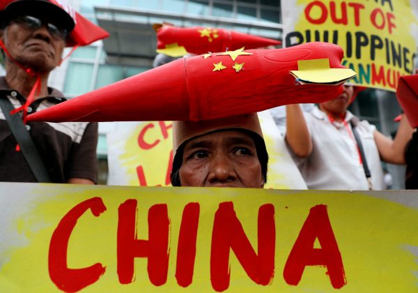 Protestors display placards during a rally by leftwing activists outside the Chinese Consulate to protest Beijing's continued reclamation activities in the South China Sea, Makati, Metro Manila, Philippines, 10 February 2018 (Photo: Reuters/Erik De Castro).
