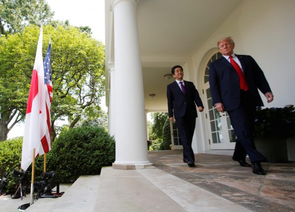 Japan's Prime Minister Shinzo Abe and US President Donald Trump arrive for a joint news conference in the Rose Garden of the White House in Washington DC, 7 June 2018 (Photo: Reuters/Carlos Barria).