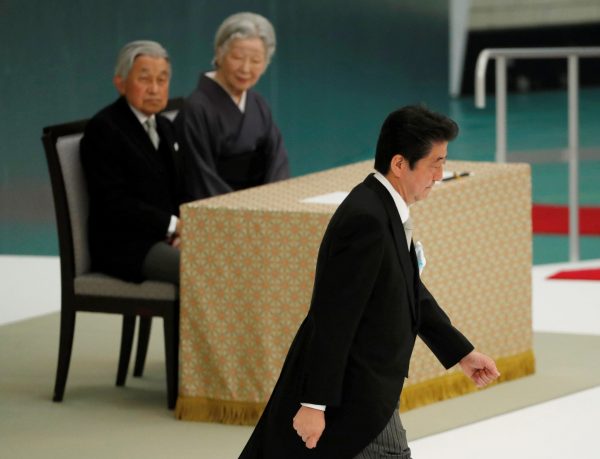 Japan's Emperor Akihito and Empress Michiko look at Japanese Prime Minister Shinzo Abe during a memorial service ceremony marking the the 73rd anniversary of Japan's surrender in World War Two, Budokan Hall, Tokyo, Japan, 15 August 2018 (Photo: Reuters/Toru Hanai).