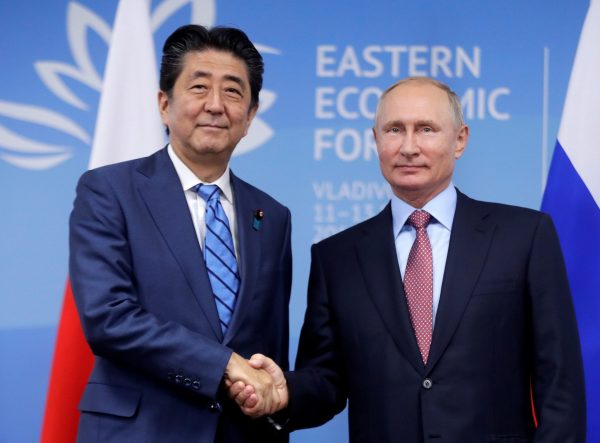 Japanese Prime Minister Shinzo Abe shakes hands with Russian President Vladimir Putin during their meeting on the sidelines of the Eastern Economic Forum in Vladivostok, Russia 10 September 2018 (Photo: Mikhail Metzel/TASS Host Photo Agency/Pool via Reuters).