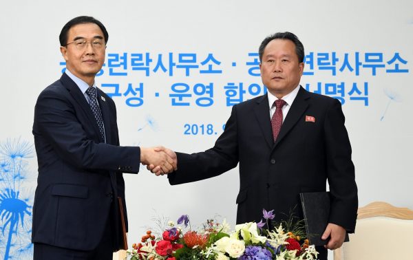 Ri Son Gwon, chairman of the Committee for the Peaceful Reunification of the Country, shakes hands with South Korean Unification Minister Cho Myoung-gyon after signing a document during an opening ceremony of the joint liaison office in Kaesong, North Korea, 14 September 2018 (Photo: Reuters/Yonhap).