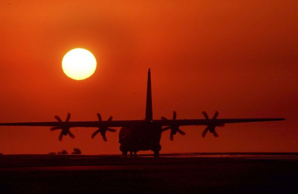 A C-130 Hercules support aircraft arrives during sunset at a Royal Australian Air Force (RAAF) base near Darwin to participate in 'Exercise Pitch Black', 15 July 2004 (Photo: Reuters/Australian Defence Force/Corporal Darren Hilder).