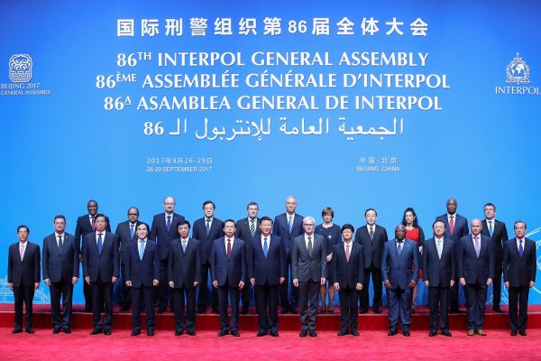 Chinese President Xi Jinping (centre), Secretary General of Interpol Jurgen Stock (right of centre) and former president of Interpol Meng Hongwei (left of centre) pose for a group photo before the 86th Interpol General Assembly at Beijing National Convention Center on 26 September 2017 in Beijing, China (Photo: Reuters/Lintao Zhang).