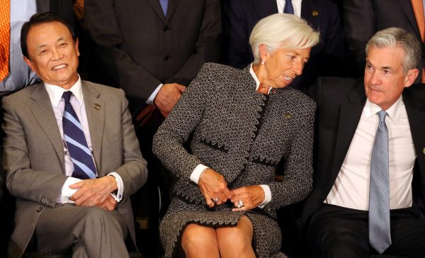 International Monetary Fund Managing Director Christine Lagarde sits alongside Jerome Powell, Chairman of the US Federal Reserve, and Japan's Minister of Finance Taro Aso as they pose for the official photo at the G20 Meeting of Finance Ministers in Buenos Aires, Argentina, 21 July 2018 (Photo: Reuters/Marcos Brindicci).