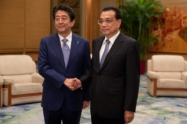 Chinese Premier Li Keqiang and Japanese Prime Minister Shinzo Abe shake hands during their meeting at the Great Hall of the People in Beijing, China, 25 October 2018 (Photo: Reuters/Roman Pilipey).