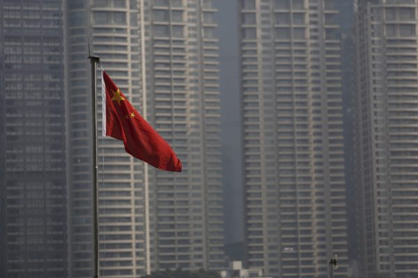 A Chinese flag is seen in front of the financial district of Pudong in Shanghai, China, 19 January 2016 (Photo: Reuters/Aly Song).